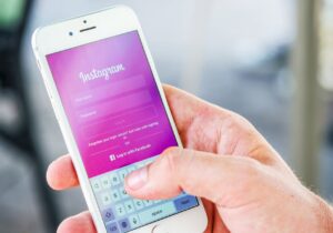 person holding phone while logging in on instagram application